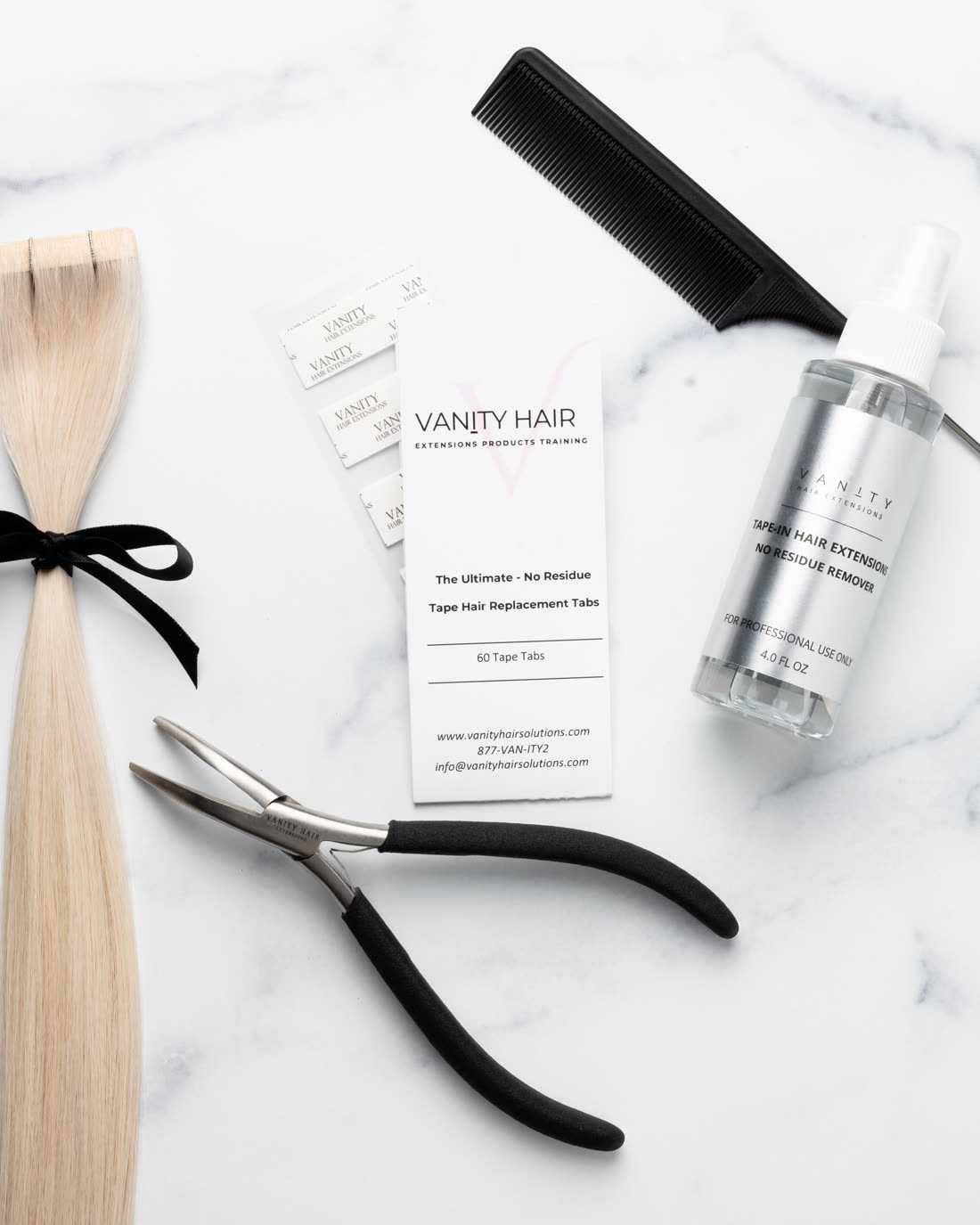 Tape extension kit laid out with a blonde tape-in weft, rattail comb and application pliers
