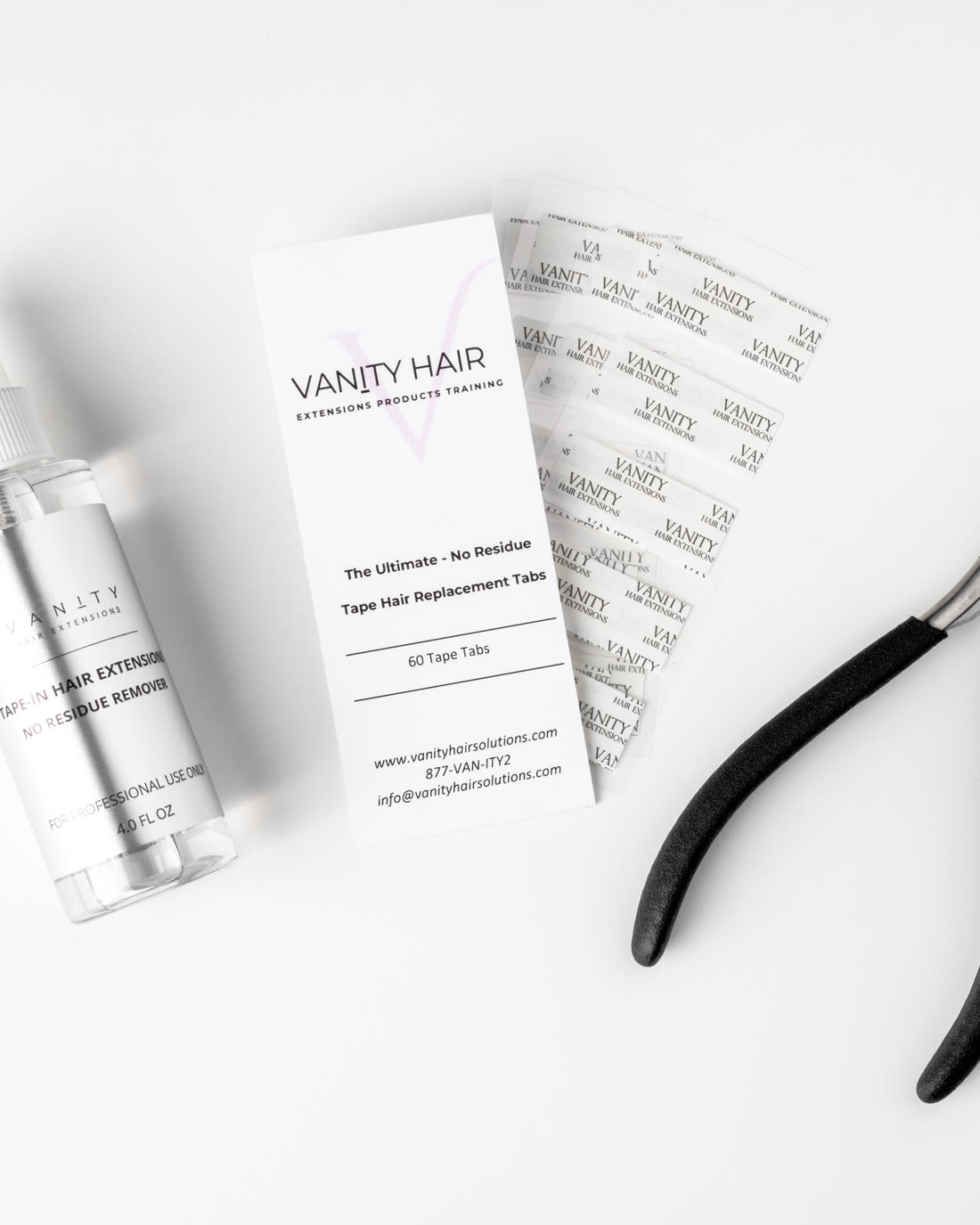 Tape extension removal kit components on white, remover bottle, tape tabs and application pliers
