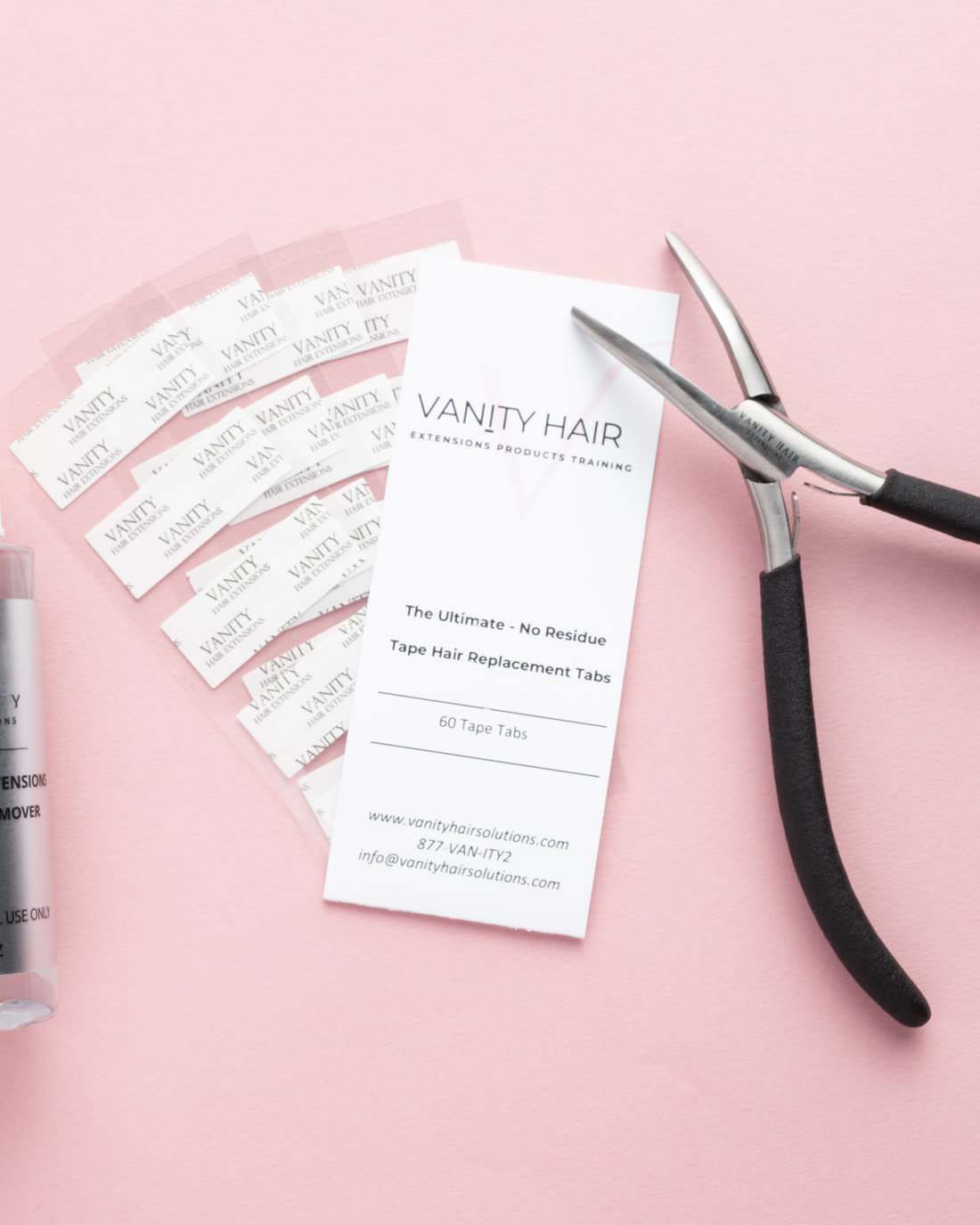 Clean tape extension remover beside fanned replacement tape tabs and application pliers