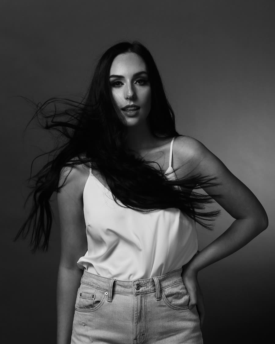 Tape-in hair extensions caught in movement against a studio backdrop
