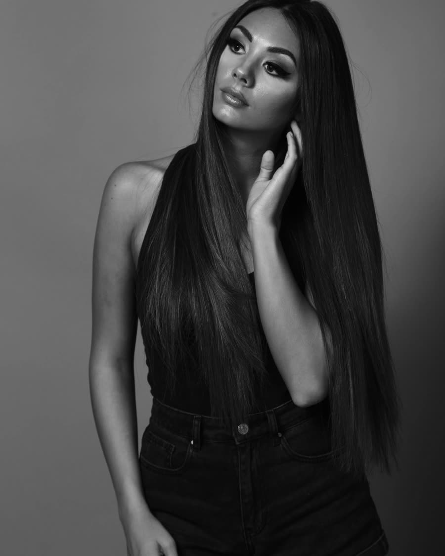 Long straight tape-in hair extensions blended at the root, studio portrait